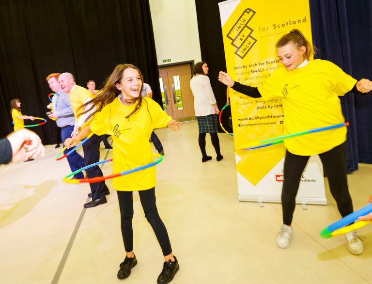 People using hoola hoops